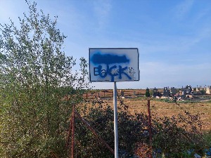 Графит "УЧК" исписан на табли са именом села Батусе